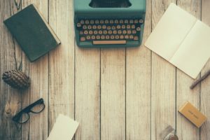 Typewriter, notebooks, writing instruments